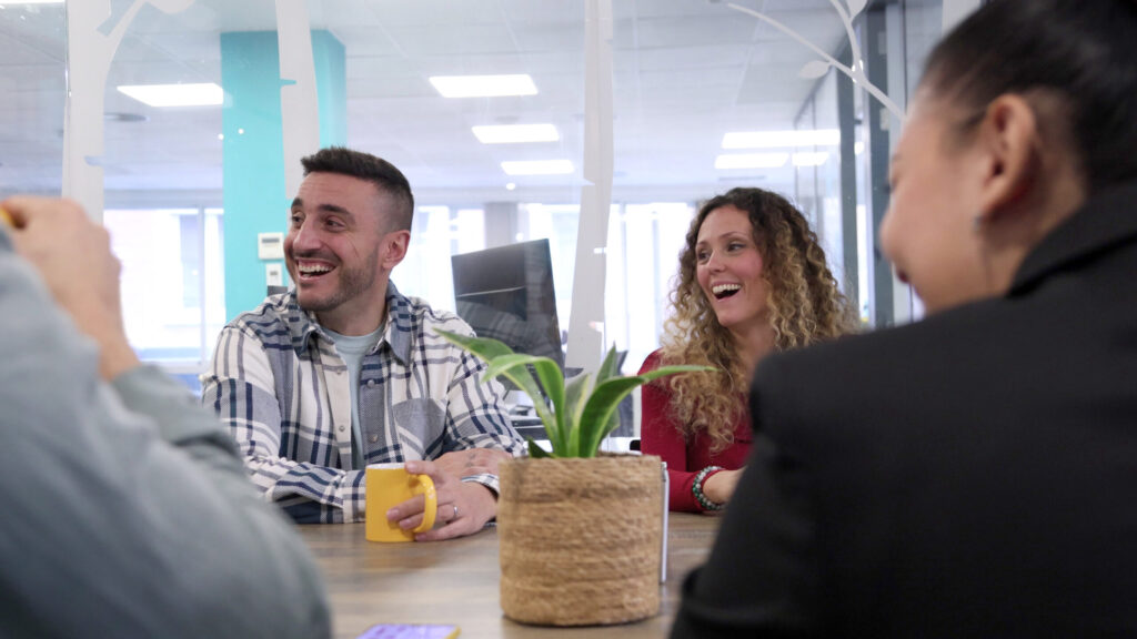 coworkers laughing at an informal meeting-Executive and Leadership Coaching in Macon, GA
