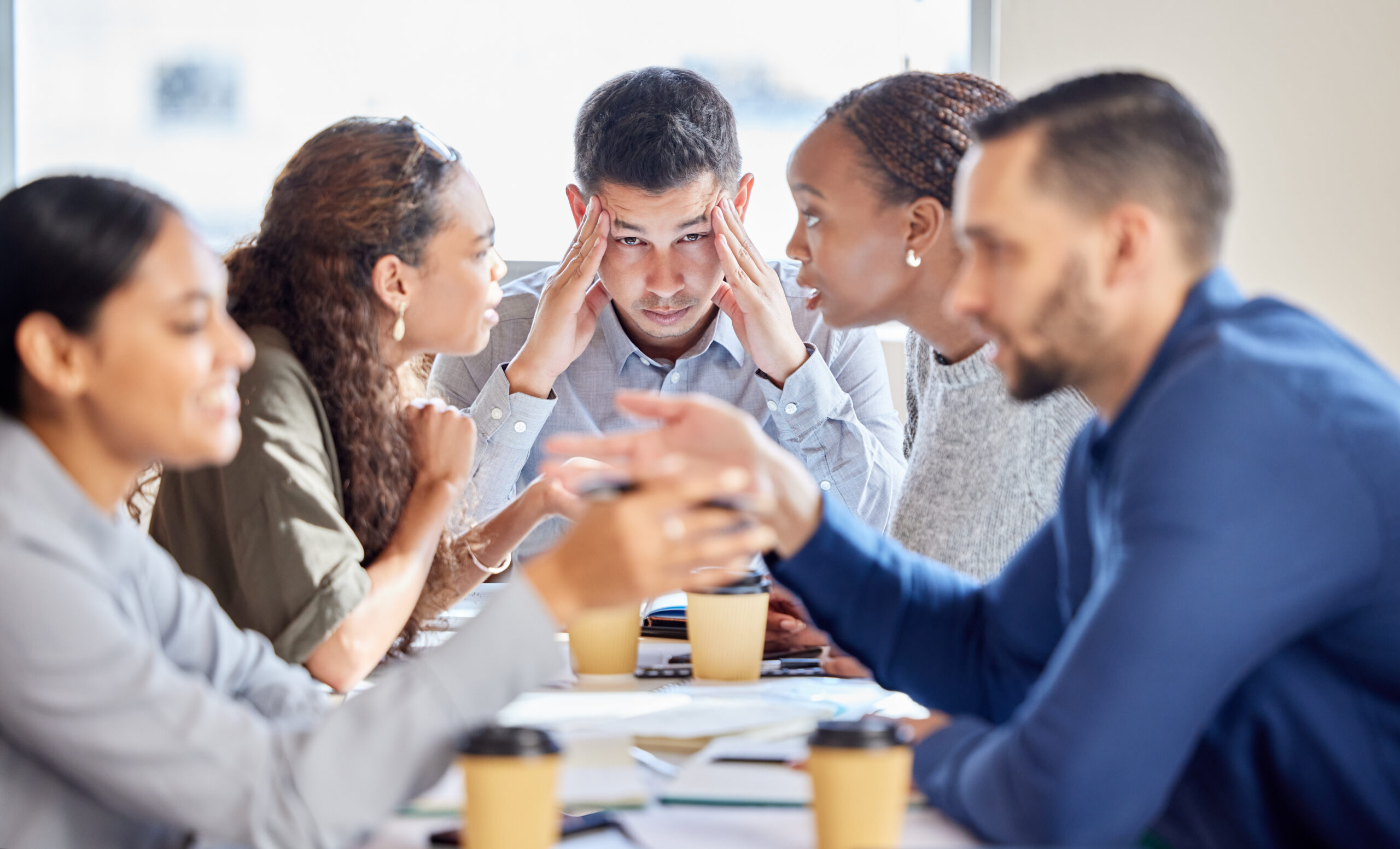 Frustrated team meeting in urban office setting